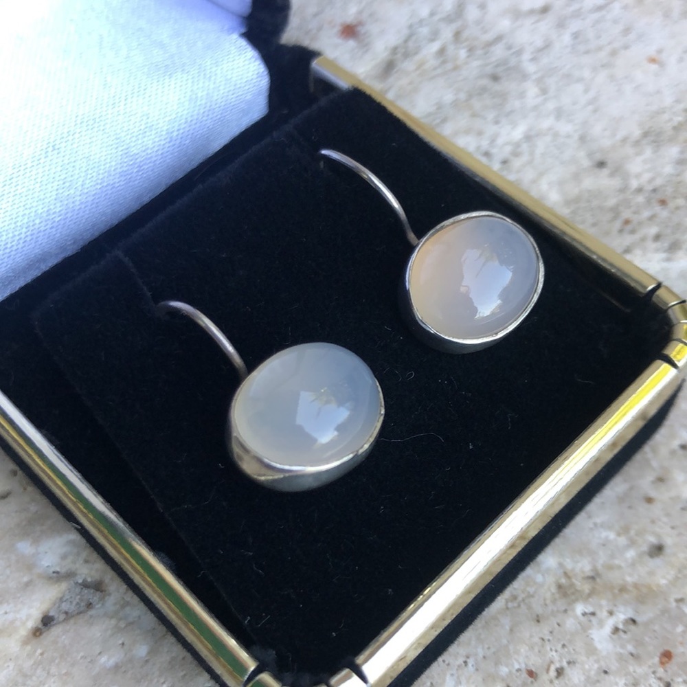 Milky white oval cabochon earrings set in 925 sterling silver